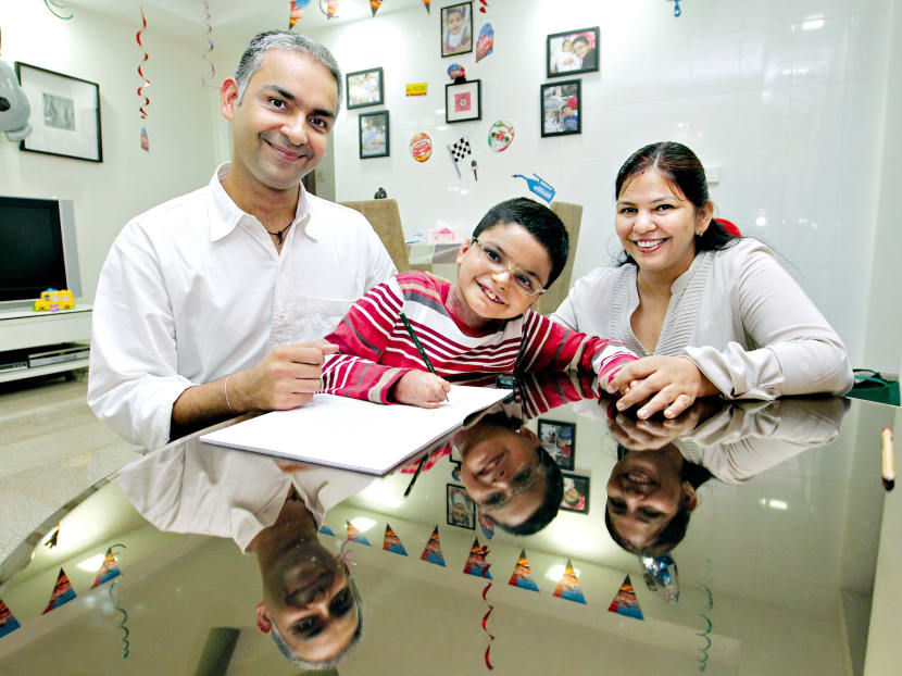 Despite the pain and surgery that he has undergone, Harshit (centre) is a cheerful boy, said his father and mother. Photo: Koh Mui Fong