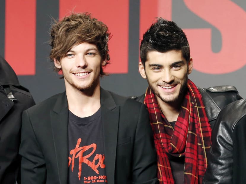 One Direction members Louis Tomlinson (L) and Zayn Malik during an event for their film One Direction: This Is US, in Makuhari, near Tokyo in this Nov 3, 2013 photo. Photo: AP