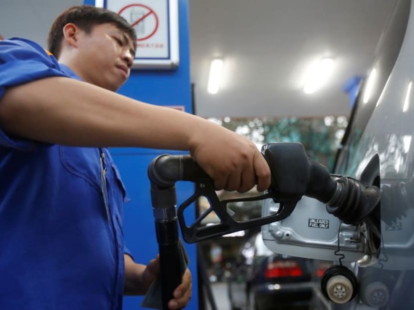 FILE PHOTO: An employee pumps petrol into a car at a petrol station in Hanoi, Vietnam December 20, 2106. REUTERS/Kham