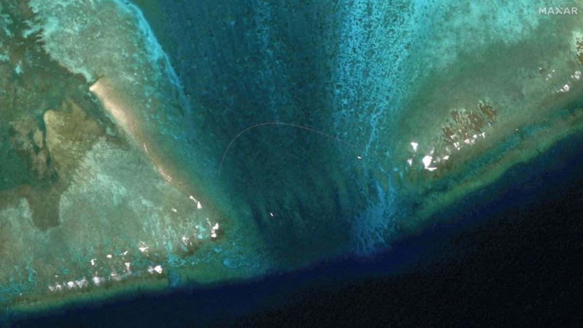 Satellite images reveal floating barrier at mouth of disputed atoll in South China Sea Satellite images reveal floating barrier at mouth of disputed atoll in South China Sea