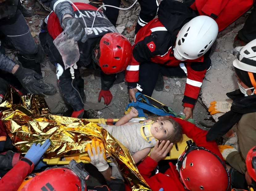 This handout picture released by the Turkish Disaster and Emergency Management Presidency (AFAD) shows rescue workers carrying a 3-year-old girl, Ayda Gezgin, out of the rubble of a collapsed building after an earthquake in the Aegean port city of Izmir, on Nov 3, 2020.