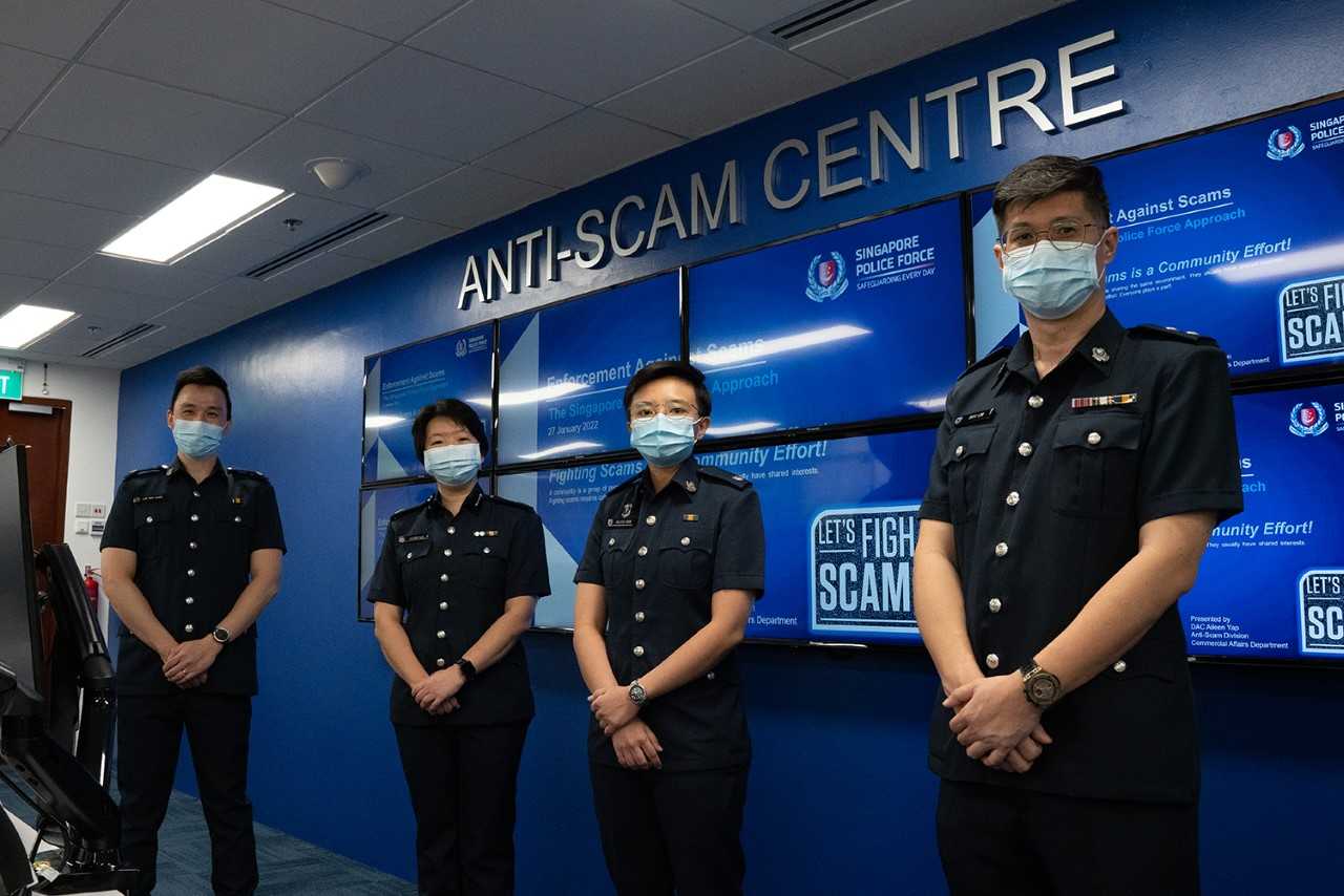 Officers of the Anti-Scam Division pose for a photo during a press event at the Police Cantonment Complex on Jan 27, 2022. From left: Assistant Superintendent of Police (ASP) Lim Min Siang, Deputy Assistant Commissioner of Police Aileen Yap, ASP Felicia Seow and Inspector Eric Low. Officers of the Anti-Scam Division pose for a photo during a press event at the Police Cantonment Complex on Jan 27, 2022. From left: Assistant Superintendent of Police (ASP) Lim Min Siang, Deputy Assistant Commissioner of Police Aileen Yap, ASP Felicia Seow and Inspector Eric Low.