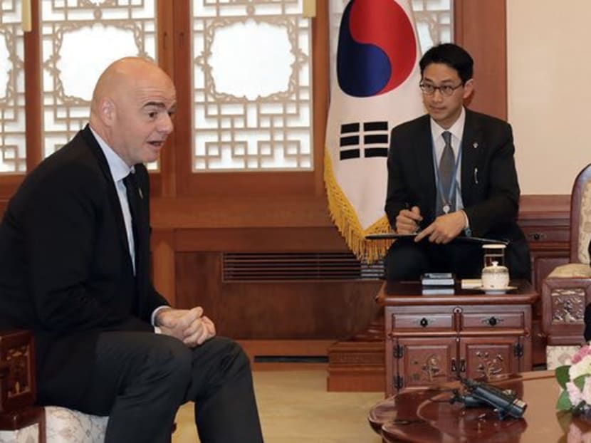 South Korea’s president Moon Jae-in, right, raised the possibility of a shared bid for the 2030 World Cup in a meeting with Fifa’s president Gianni Infantino, left. Photograph: Bae Jae-man/AP