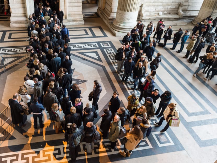 People queue as police controls everybody who wants to enter the Palace of Justice in Brussels yesterday (Jan 16). Thirteen people were detained in Belgium and two arrested in France in an anti-terror sweep following a firefight in which two suspected terrorists were killed in the eastern city of Verviers on Thursday. Photo: AP