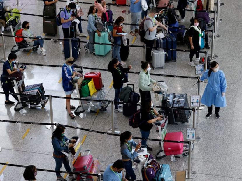 FILE PHOTO: Travellers queue up for shuttle bus to quarantine hotels at the Hong Kong International Airport, amid the coronavirus disease (COVID-19) pandemic, in Hong Kong, China, August 1, 2022. REUTERS/Tyrone Siu FILE PHOTO: Travellers queue up for shuttle bus to quarantine hotels at the Hong Kong International Airport, amid the coronavirus disease (COVID-19) pandemic, in Hong Kong, China, August 1, 2022. REUTERS/Tyrone Siu
