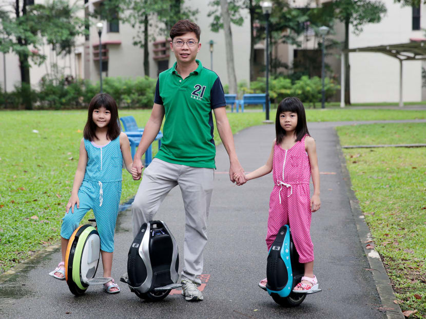 Mr Jeffrey Chan and his daughters Juel (in blue) and Kyae on unicycles. A growing group of people are zipping around Singapore on Personal Mobility Devices as part of their daily commute. Photo: Jason Quah