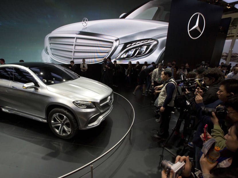 Visitors look at the latest model from Mercedes at an auto show in Beijing, where a survey by the American Chamber of Commerce in China found that nearly half of foreign companies in China feel singled out in a wave of anti-monopoly and other investigations and a growing number are deciding not to expand their investments. Photo: AP