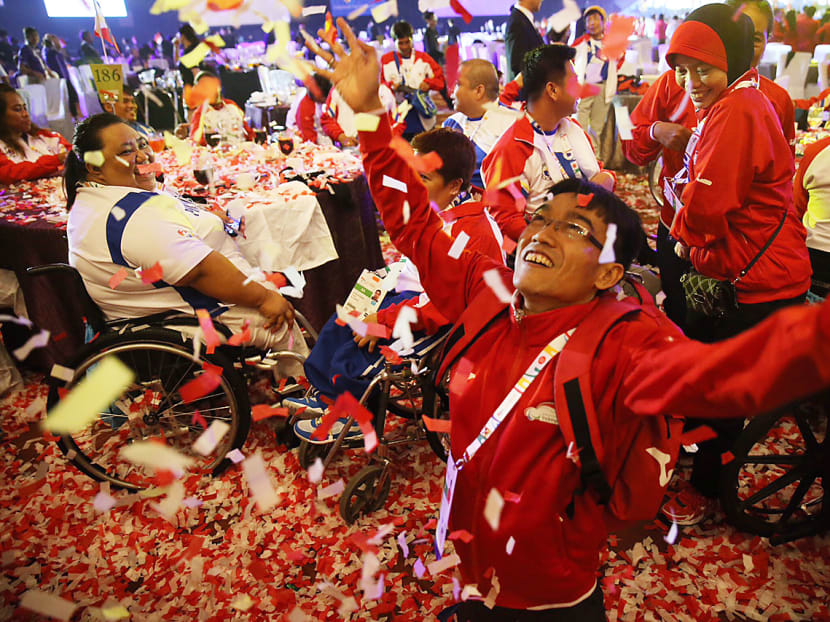 Para athletes from Philippines and Indonesia tossing confetti during the closing ceremony of the 8th ASEAN Para Games 2015. Photo: Don Wong