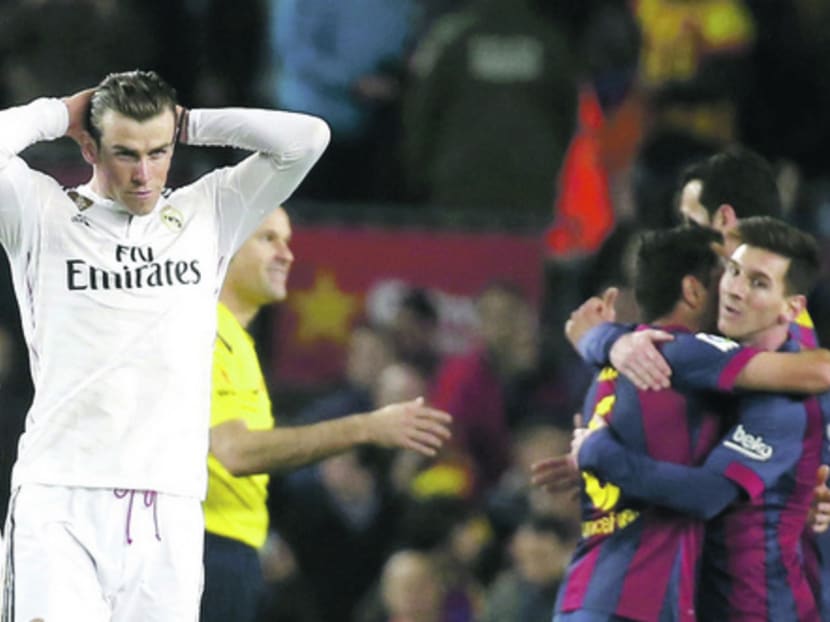 Bale (left), seen here as Barcelona players celebrate at the end of their win at Camp Nou on Sunday, was unfortunate not to score in the first half. Photo: REUTERS