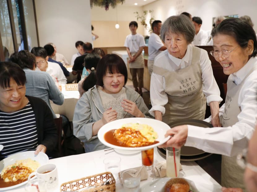 Waitresses serve a meal to customers at "The Restaurant of Order Mistakes" in Roppongi, central Tokyo on September 16, 2017. Photo: Kyodo