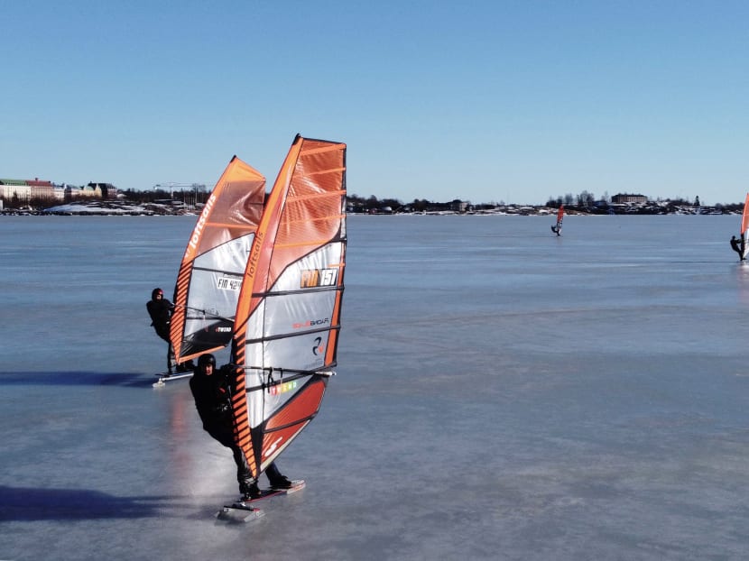 An aerial photo taken on February 28, 2021 shows ice surfers skating across the frozen Baltic Sea off the coast of Helsinki. An aerial photo taken on February 28, 2021 shows ice surfers skating across the frozen Baltic Sea off the coast of Helsinki.