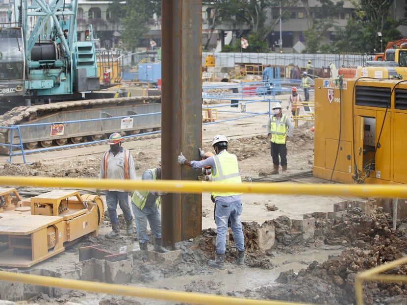 Workers at a construction site along Ophir Road on May 13, 2022.