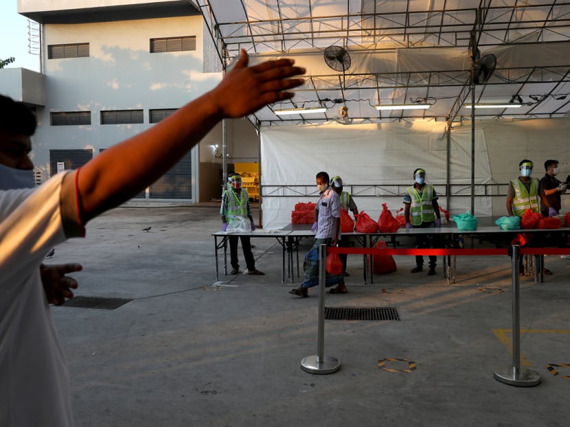 Foreign workers in Westlite Papan dormitory collecting their catered breakfast on April 21, 2020.