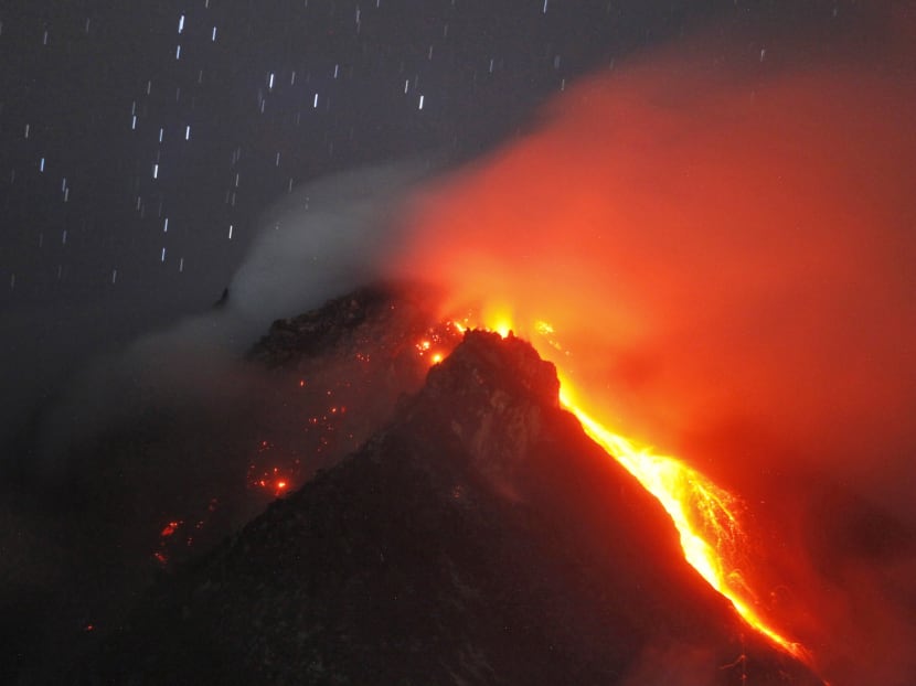 In this photo taken using slow shutter speed, hot lava flows from the crater of Mount Sinabung as seen from Tiga Serangkai, North Sumatra, Indonesia, early Monday, June 15, 2015.  Photo: AP