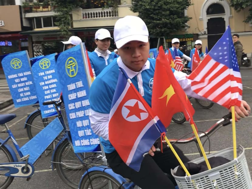 Courtesy ambassadors cycling through central Hanoi, reminding locals to be on their best behaviour.