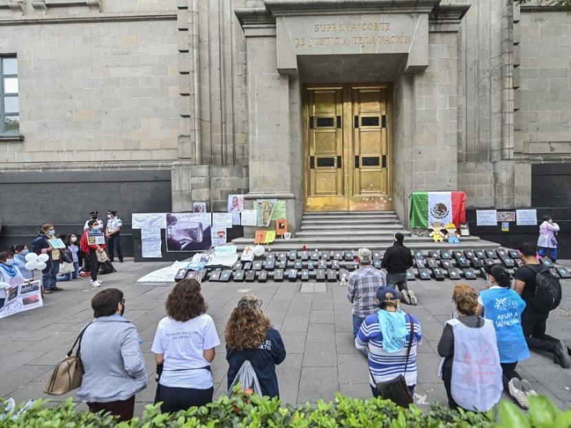 In this file photo taken on July 29, 2020, Catholic anti-abortion activists pray during a protest outside the Mexican Supreme Court building in Mexico City, amid the novel coronavirus pandemic. Mexico's Supreme Court on Sept 7, 2021 declared the criminalization of abortion unconstitutional in a unanimous vote hailed by rights campaigners in the conservative Latin American country.