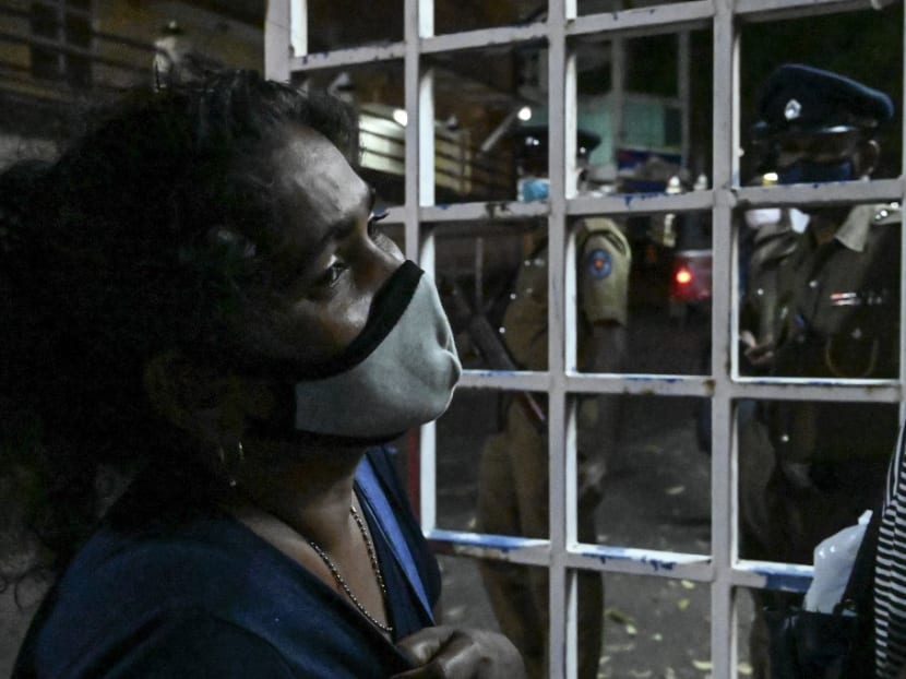 A relative of an inmate weeps at Ragama hospital on the outskirts of Colombo on Nov 30, 2020 a day after a prison riot over the surge of coronavirus infections.