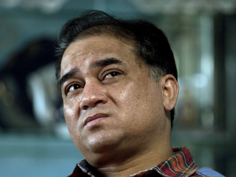 In this Feb 4, 2013 photo, Ilham Tohti, an outspoken scholar of China's Turkic Uighur ethnic minority, pauses during an interview at his home in Beijing, China. A Chinese court Tuesday, Sept 23, 2014 imposed a harsh life sentence on Tohti, who championed the country's Uighur minority, the most severe penalty in a decade for anyone in China convicted of illegal political speech. Photo: AP
