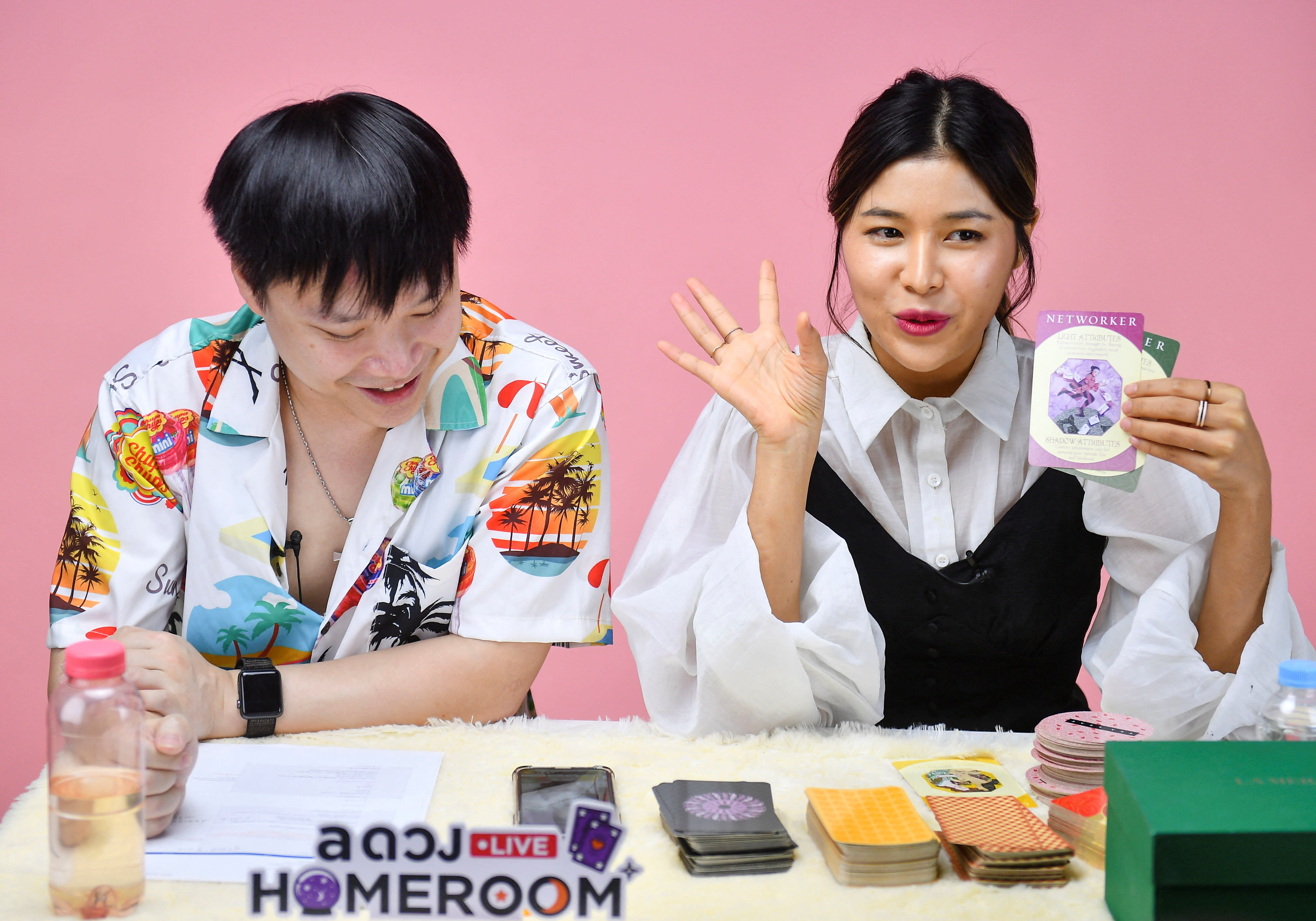 Fortune-tellers livestream a card reading session on an online platform, as many young Thais increasingly seek divination for quick answers, at their office in Bangkok, Thailand on March 30, 2022. 
