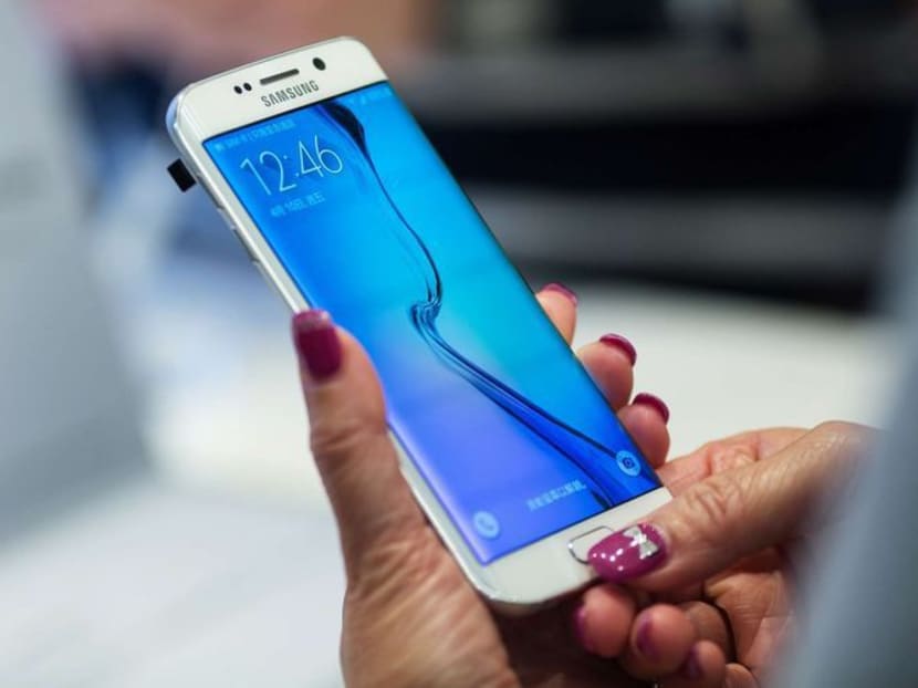 An attendee tries a Samsung Galaxy S6 Edge smartphone at a launch event in Hong Kong on April 10. Photo: Bloomberg