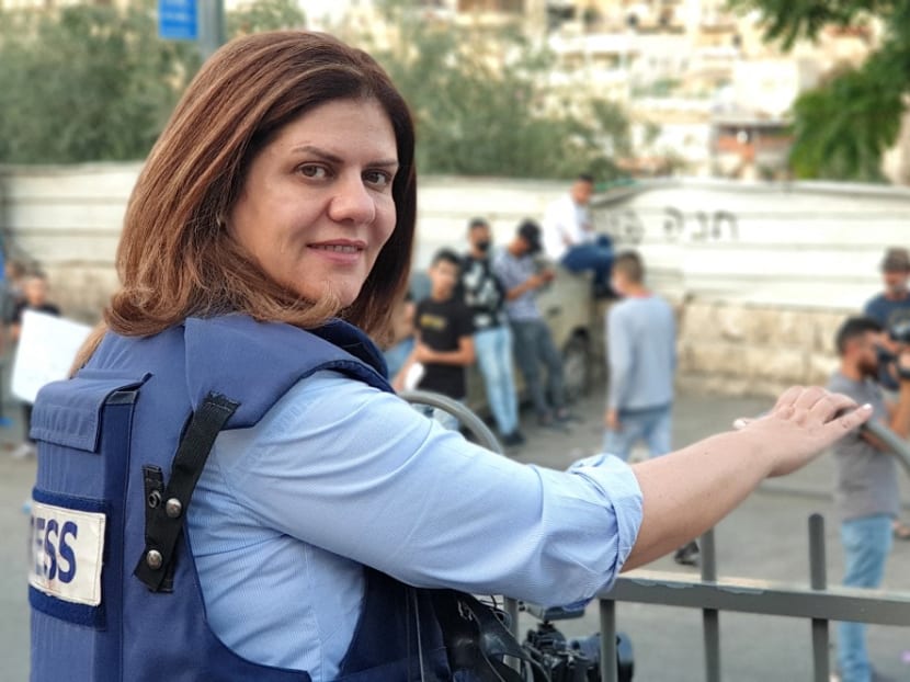 This handout file picture obtained from a former colleague of Al-Jazeera's slain veteran TV journalist Shireen Abu Akleh, shows her reporting from Jerusalem on June 12, 2021. 
