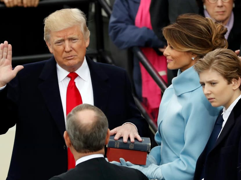 US President Donald Trump takes the oath of office with his wife Melania and son Barron at his side, during his inauguration at the US Capitol in Washington, US, on Jan 20, 2017. Photo: Reuters