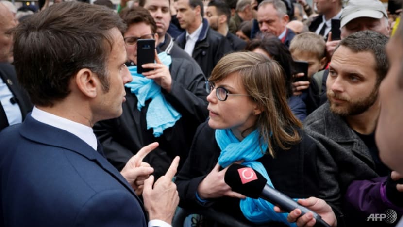 Macron booed by angry French after signing pensions reform