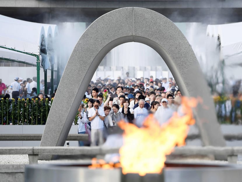 People praying in front of the cenotaph for victims of the 1945 atomic bombing at Peace Memorial Park in Hiroshima yesterday. The blast killed 140,000 people. Photo: Reuters