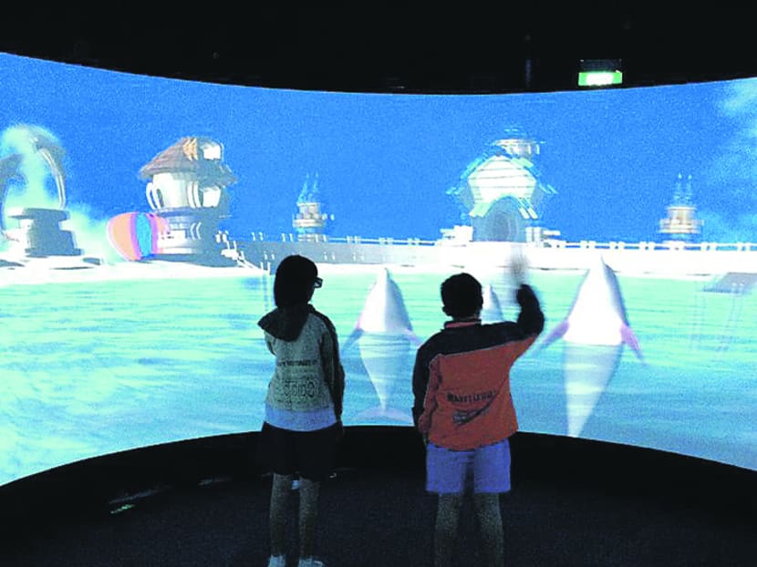 Children with autism interacting with 3D dolphins. Photo: Institute For Media Innovation, NTU