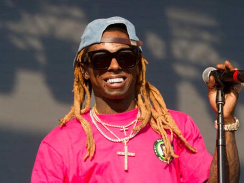 Rapper Lil Wayne charged with gun possession by a convicted felon Rapper Lil Wayne charged with gun possession by a convicted felon