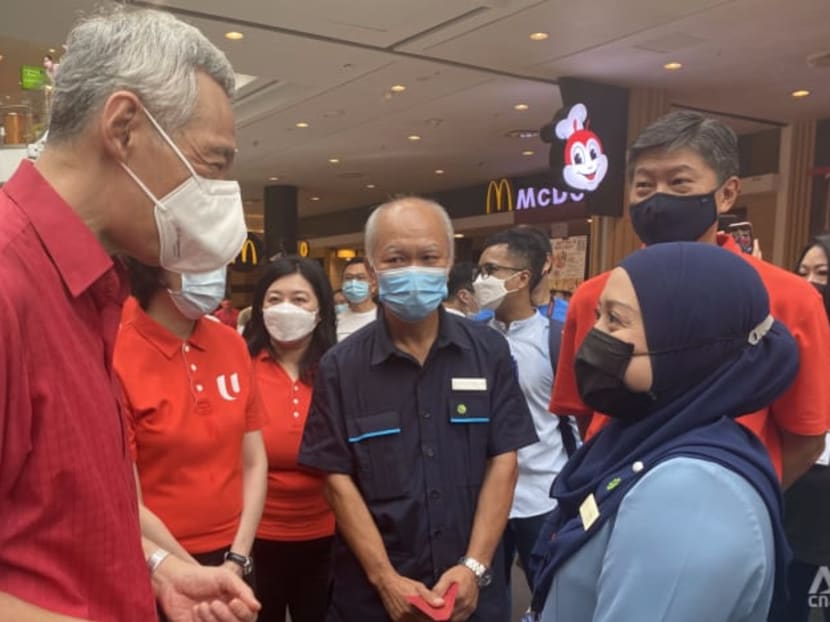 Prime Minister Lee Hsien Loong speaking to customer service officer Irnawati Rohen at Jurong Point on the eve of Chinese New Year, Jan 31, 2021.