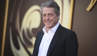 Hugh Grant says he got 'enormous sum' to settle suit alleging illegal snooping by The Sun tabloid