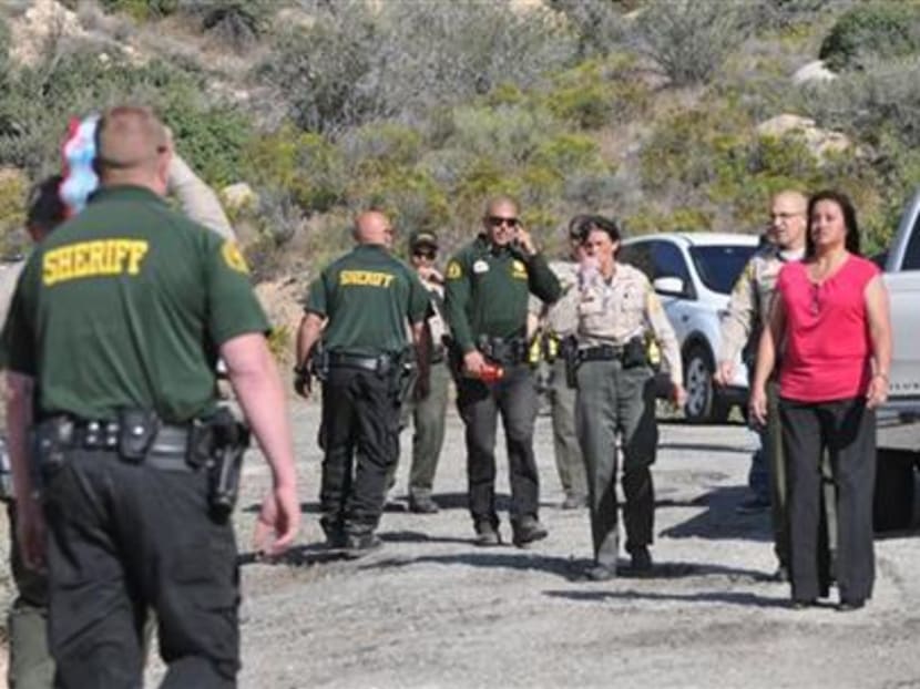 Law enforcement personnel search for a suspect who stole a horse and fled into the mountains near Deep Creek in Apple Valley, California, on Thursday, April 9, 2015. Photo: AP