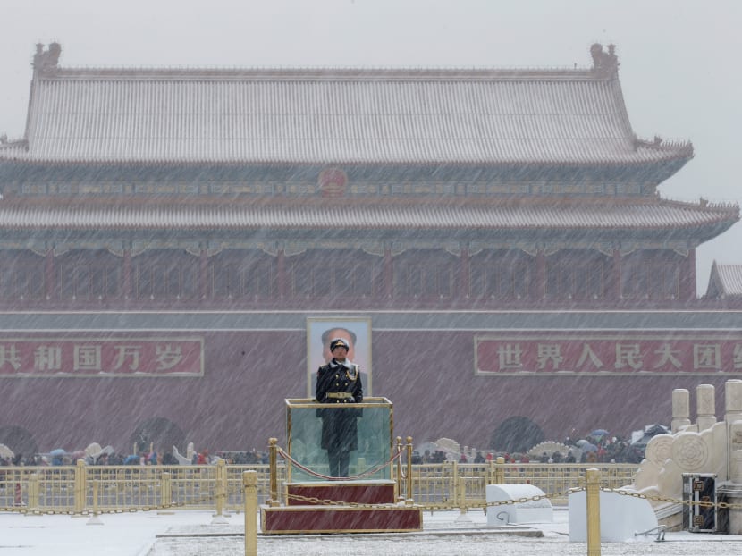 Photo of the day: A paramilitary officer stands guard amid snow at the Tiananmen Square in Beijing.