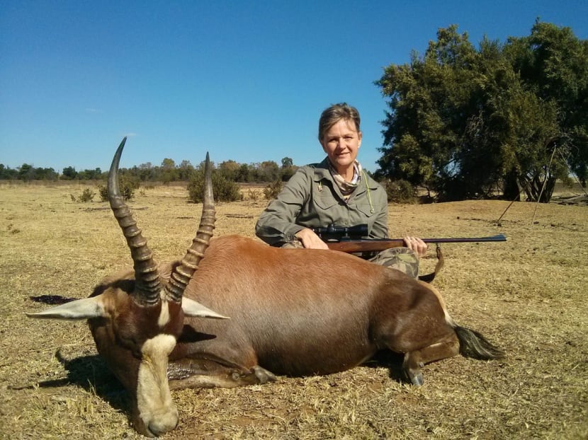 Professional Hunters' Association of South Africa chief executive officer Adri Kitshoff poses with her rifle after hunting a blesbok. Photo: Bloomberg