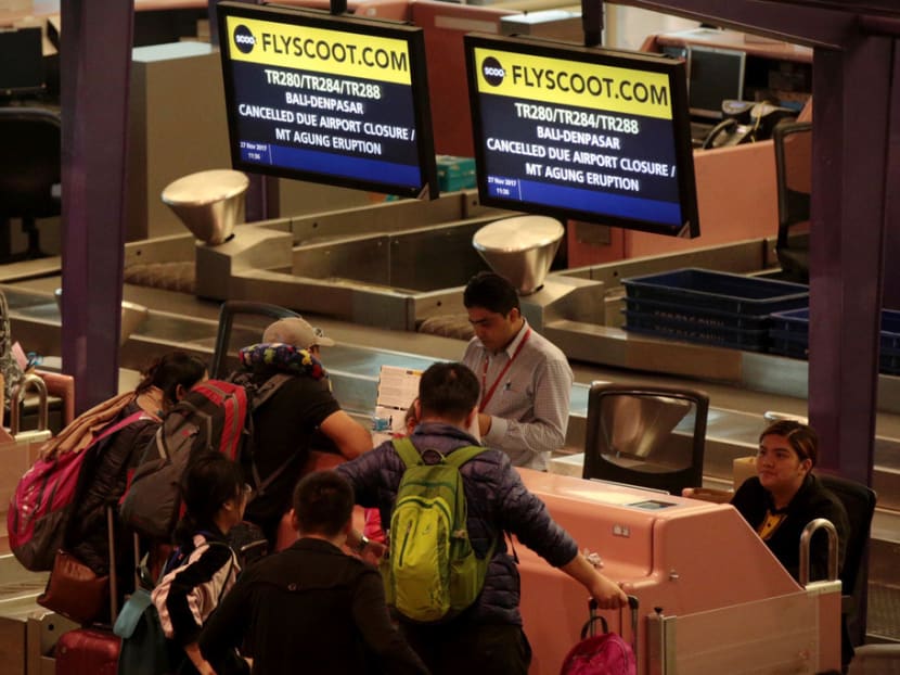 Passengers were seen at the Scoot counter at Changi Airport on Monday (Nov 27) after flights to Bali were cancelled following Mount Agung eruption. Photo: Jason Quah/TODAY