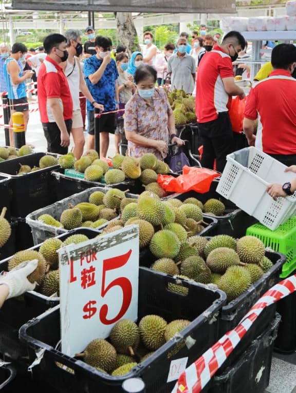 People in Singapore queueing to buy durians in June 2021. People in Singapore queueing to buy durians in June 2021.
