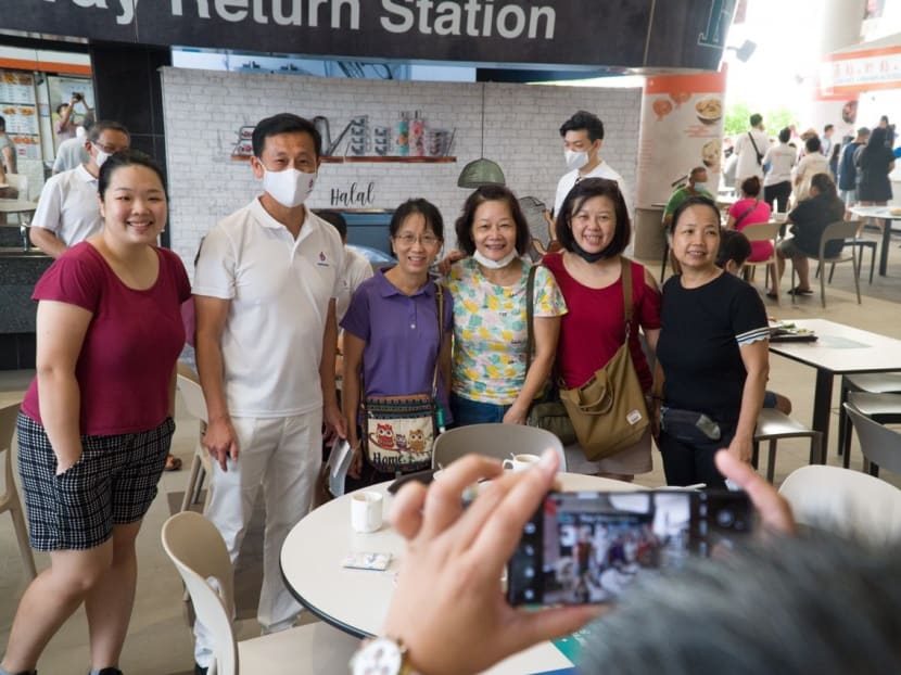 Mr Ong Ye Kung (second from left), who is leading the PAP's Sembawang GRC team, stopping for a picture with residents in the morning while on a walkabout at Kampung Admiralty on July 5, 2020.