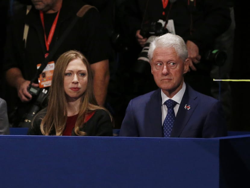 Chelsea Clinton and her father, former U.S.  President Bill Clinton sit together at the presidential town hall debate between Republican U.S. presidential nominee Donald Trump and Democratic U.S. presidential nominee Hillary Clinton at Washington University in St. Louis, Missouri, U.S., October 9, 2016. Photo: Reuters