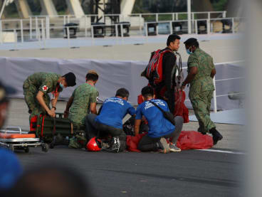 Medical personnel attending to 3WO Jeffrey Heng after the parachutist's hard landing at the National Day Parade on Aug 9, 2022.