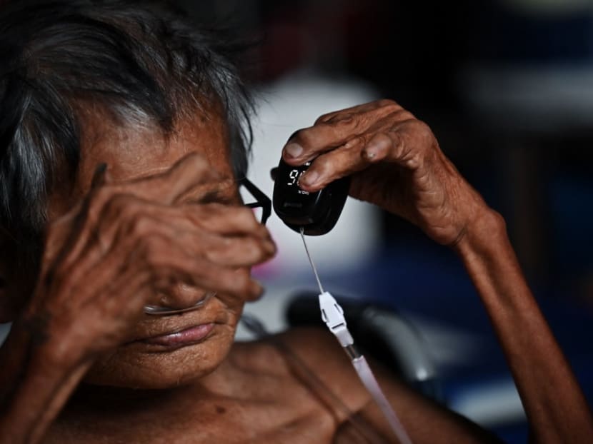 An elderly Covid-19 patient waits to be transferred to a hospital in Bangkok on July 30, 2021.