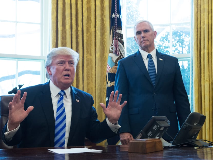 US President Donald Trump (seated) and Vice President Mike Pence. Photo: AFP