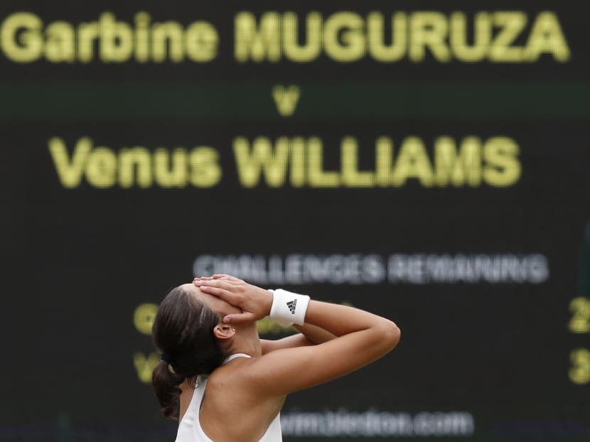 An emotional Garbine Muguruza covers her face after she hits the winner past Venus Williams in the Wimbledon women's singles final. Photo: AFP