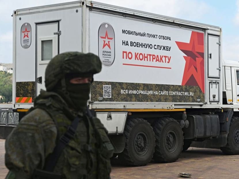 A Russian service member stands next to a mobile recruitment centre for military service under contract in Rostov-on-Don, Russia on Sept 17, 2022. A Russian service member stands next to a mobile recruitment centre for military service under contract in Rostov-on-Don, Russia on Sept 17, 2022.
