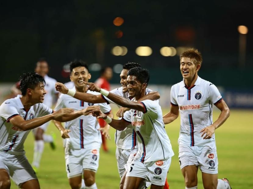 Fazli Jaffar is mobbed by his Warriors FC teammates after he scores a late equaliser to earn a 2-2 draw for his side and deny Home United three points. Photo: S.League