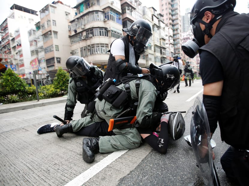 Police officers subdue an anti-government protester near Sham Shui Po police station in Hong Kong on Aug 11, 2019. Police officers subdue an anti-government protester near Sham Shui Po police station in Hong Kong on Aug 11, 2019.