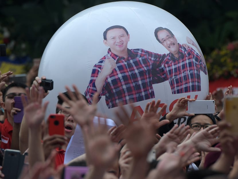 Supporters of former Jakarta governor Basuki Tjahaja Purnama, popularly known as Ahok, gather at city hall a day after after a court sentenced him to two years in jail following blasphemy charges, in Jakarta. Photo: Reuters