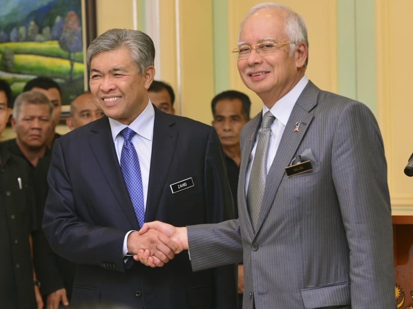 Malaysia's Prime Minister Najib Razak, right, shakes hands with his newly-appointed Deputy Prime Minister Ahmad Zahid Hamidi after addressing a press conference at the Prime Minister's office in Putrajaya  Malaysia,Tuesday, July, 28, 2015. AP file photo