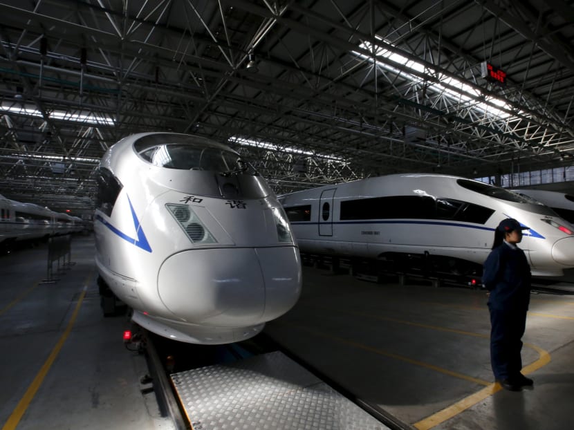 An employee stands next to high speed railway model CRH380B trains at a production line of its parts at China CNR's Tangshan Railway Vehicle's factory in Tangshan, Hebei province. Reuters file photo