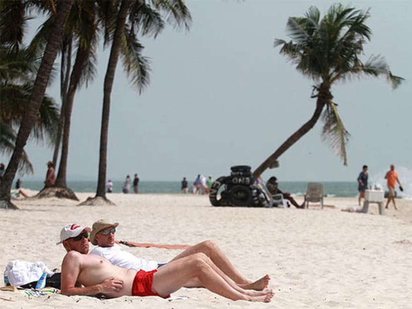 Laying down the law: Tourists in Hua Hin used to be herded onto sun loungers. Since regulations to restrict beach furniture came in, many sit on the sand, but not everyone is happy about the changes. Photo: The Bangkok Post